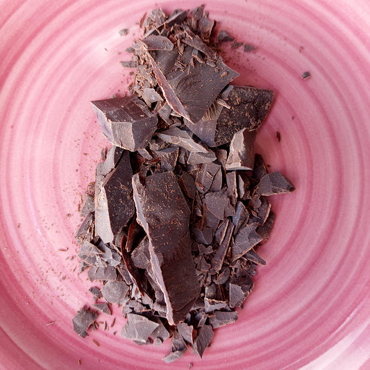 ceremonial cacao shaved on a pink plate